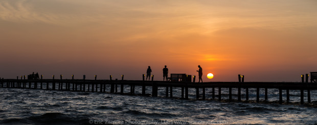 One of my favorite photos from Anna Maria Island, this is of city pier visitors enjoying the first light of the day. It's a made-for-panorama format with the long, horizontal pier stretching into the waters of Tampa Bay. Anna Maria Island, Holmes Beach, Bradenton, Florida.